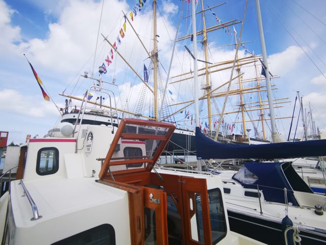 Molly neben einem großen Segelschiff